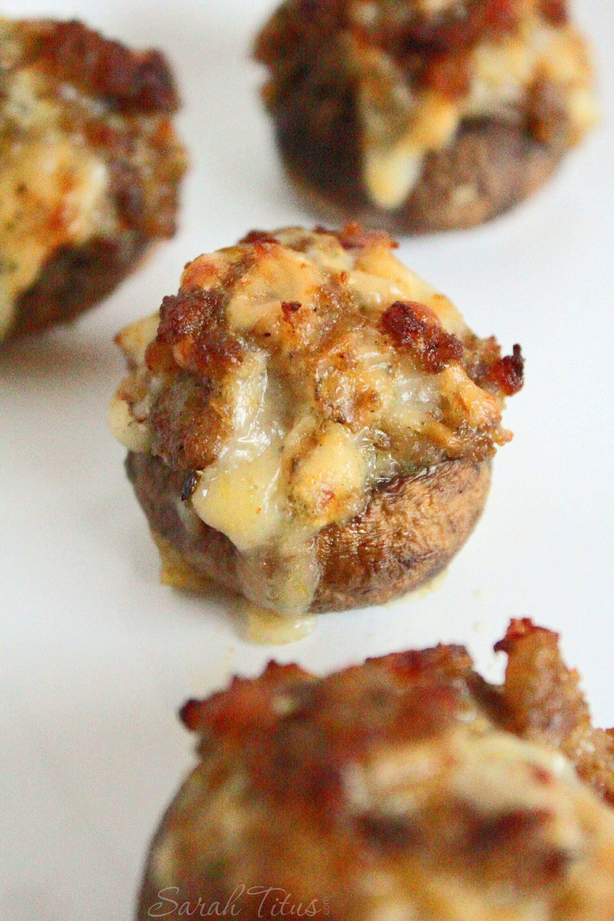 The delicious looking cooked Bite Size Stuffed Mushrooms with Sausage and Arugula