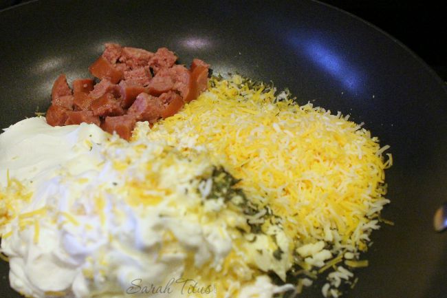 Add to a pan: sausage, cheese, sour cream, parsley, butter, garlic, and milk