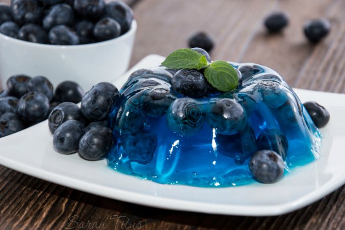 Blue Jello with blueberries and mint leaves