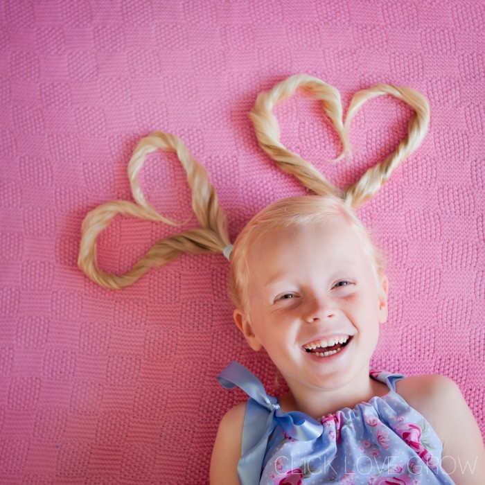 Fun shot of a smiling little girl with a fun hairdo