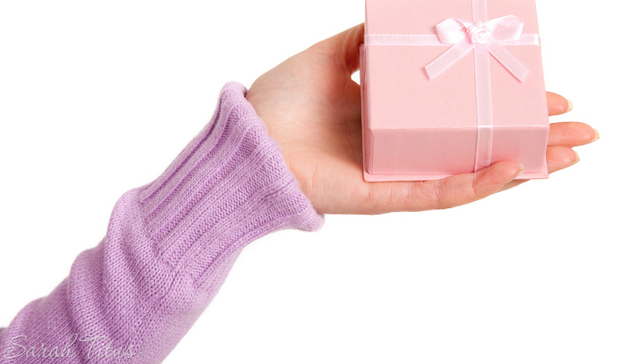 Girl holding a small pink gift box