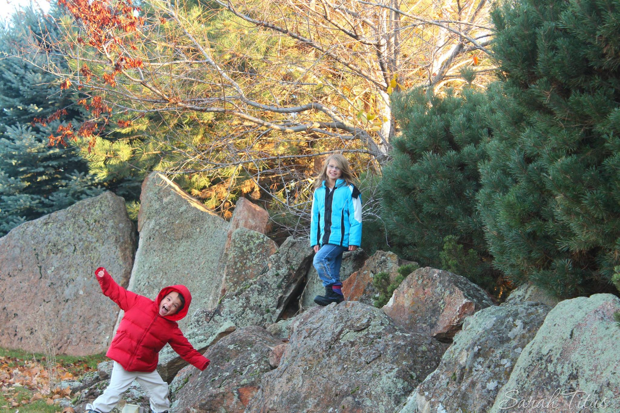 Happy Kids climbing on rocks and posing for a picture