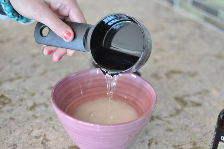 Combining the sugar and Fractionated Coconut Oil into a mixing bowl