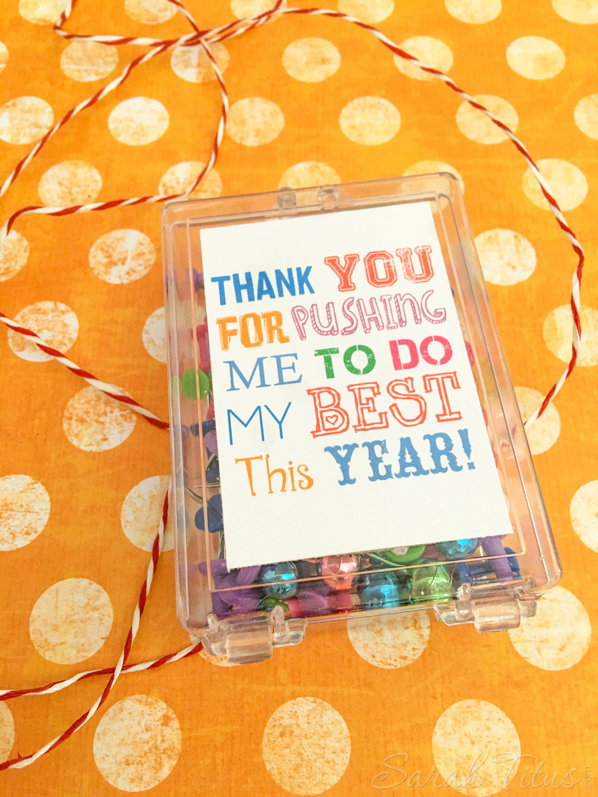 Easy Teacher Appreciation Free Printable on plastic case full of colorful pushpins on an orange and white polka dot background with red and white twine