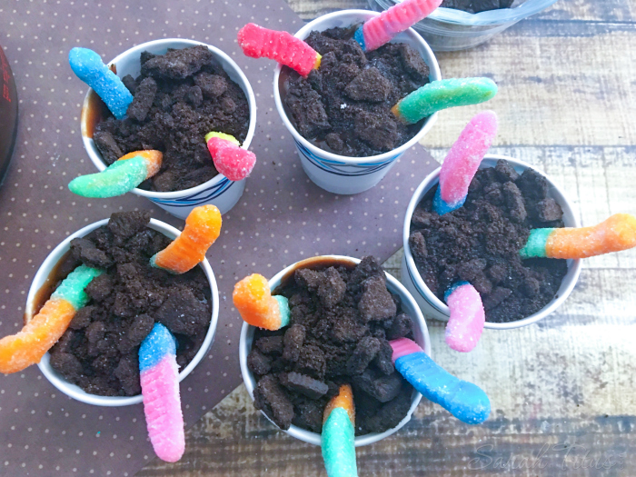Filled cups with chocolate pudding and topped with crushed Oreo's and 3 gummy worms 