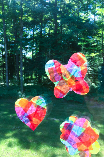 These tissue paper suncatchers are so fun to make and they keep the little ones entertained for hours! Put ribbon on the ends and fly them around the house like a kite!