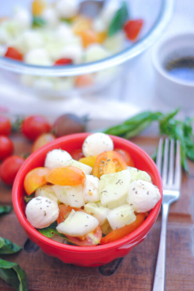 This Cucumber and Tomato Caprese Salad marries the flavors of tomato, basil, and mozzarella cheese together perfectly. This is one salad recipe you won't want to miss!