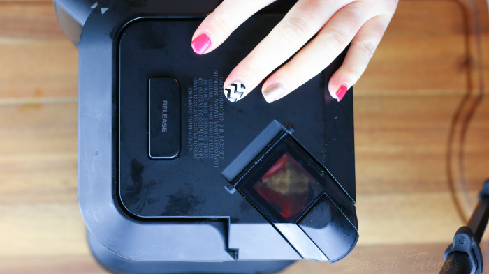 Woman's hand on blender lid ready to blend roasted red pepper hummus ingredients