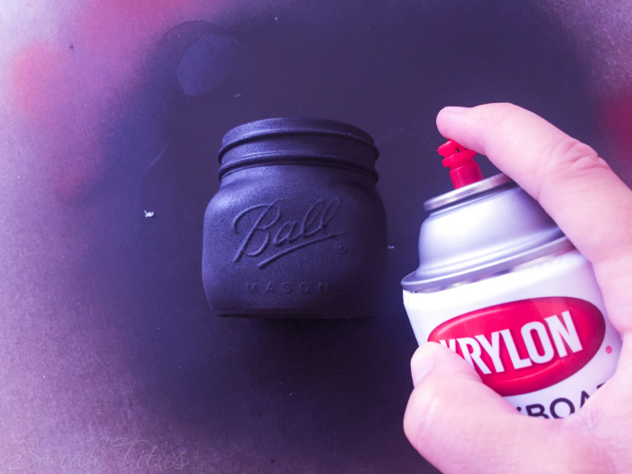 Spray painting mason jar with Chalkboard Paint
