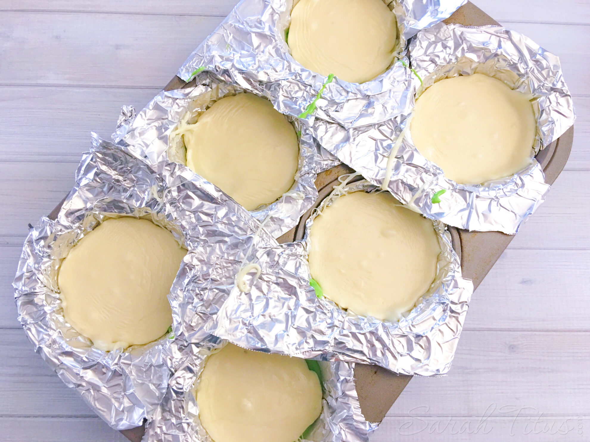 White chocolate layer for Watermelon Fudge layered on top of green layer in muffin tin