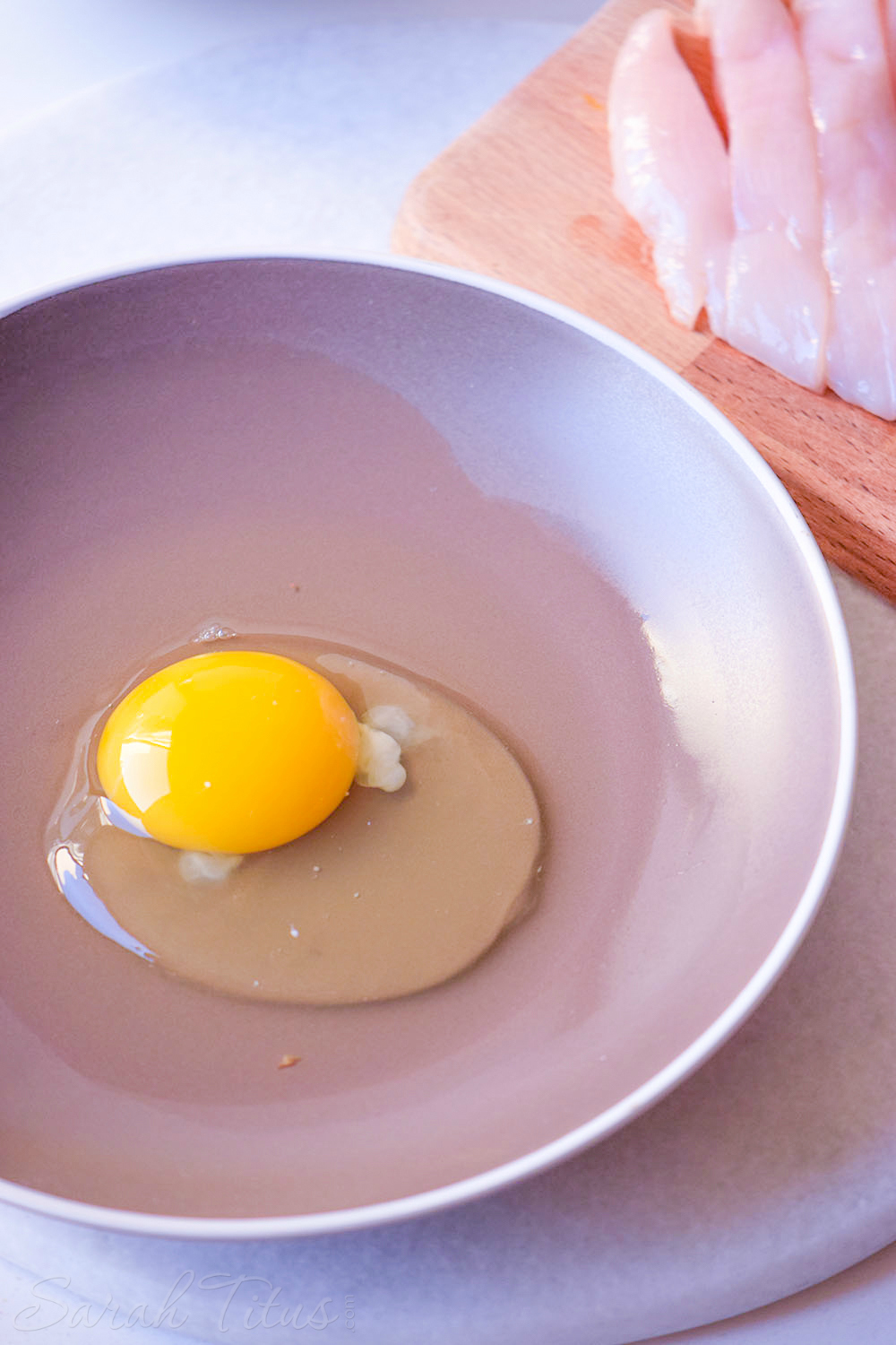 Egg in a bowl in preparation for making chicken tenders