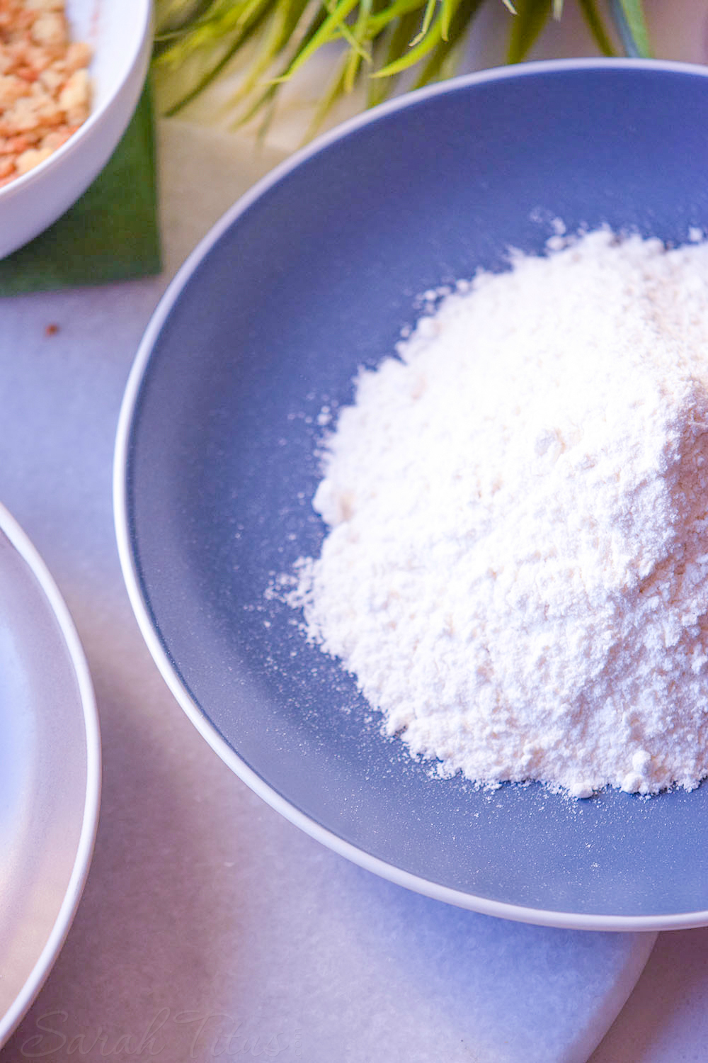 Blue bowl of flour to coat the chicken tenders in