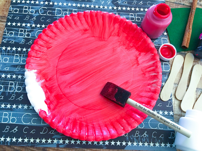 Painting paper plate red for the Paper Plate Apple {Kids Craft}