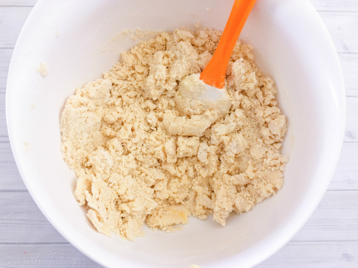 Adding flour and salt to the crumbly cookie batter