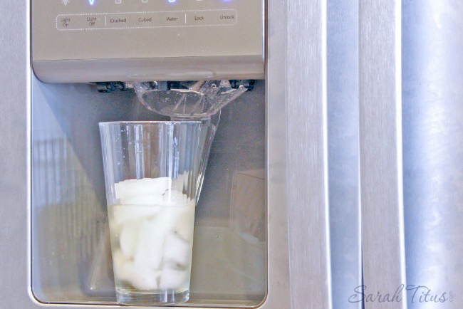 Filling glass with ice from refrigerator ice maker