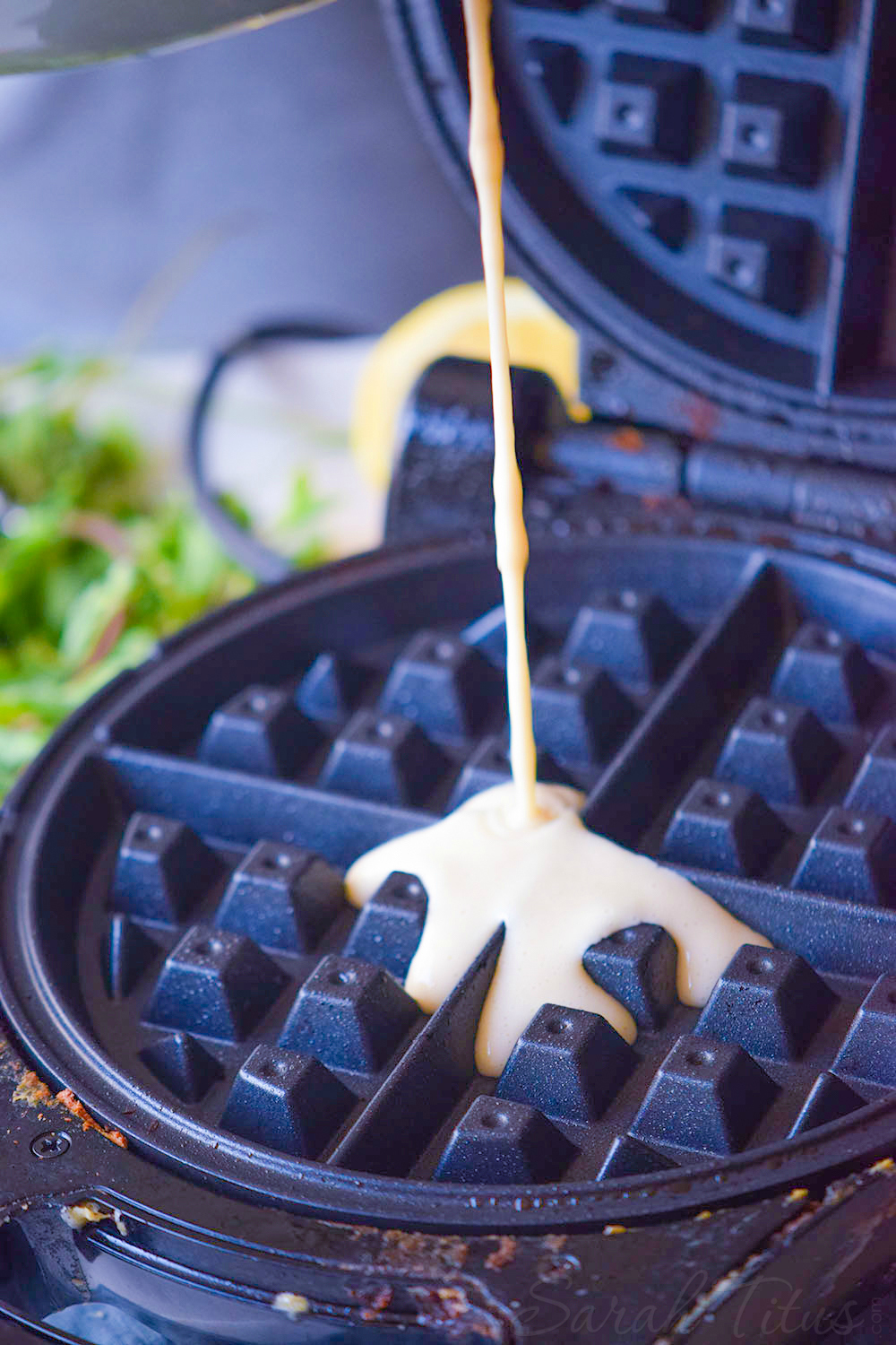 Pouring waffle batter onto hot waffle maker