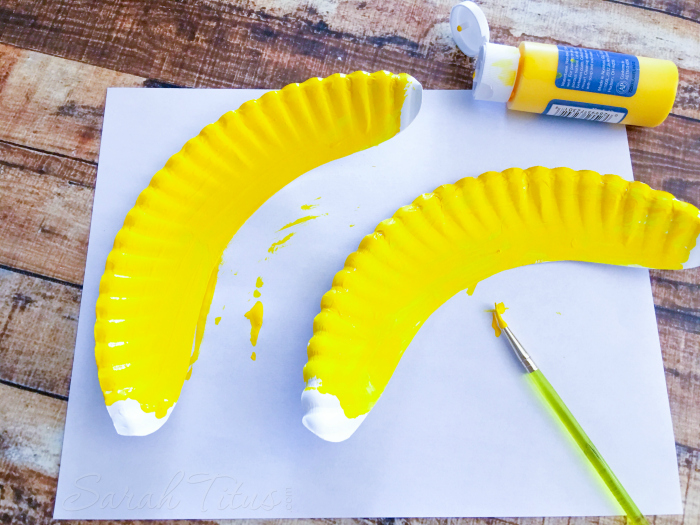 Banana shaped cut paper plates painted yellow like bananas