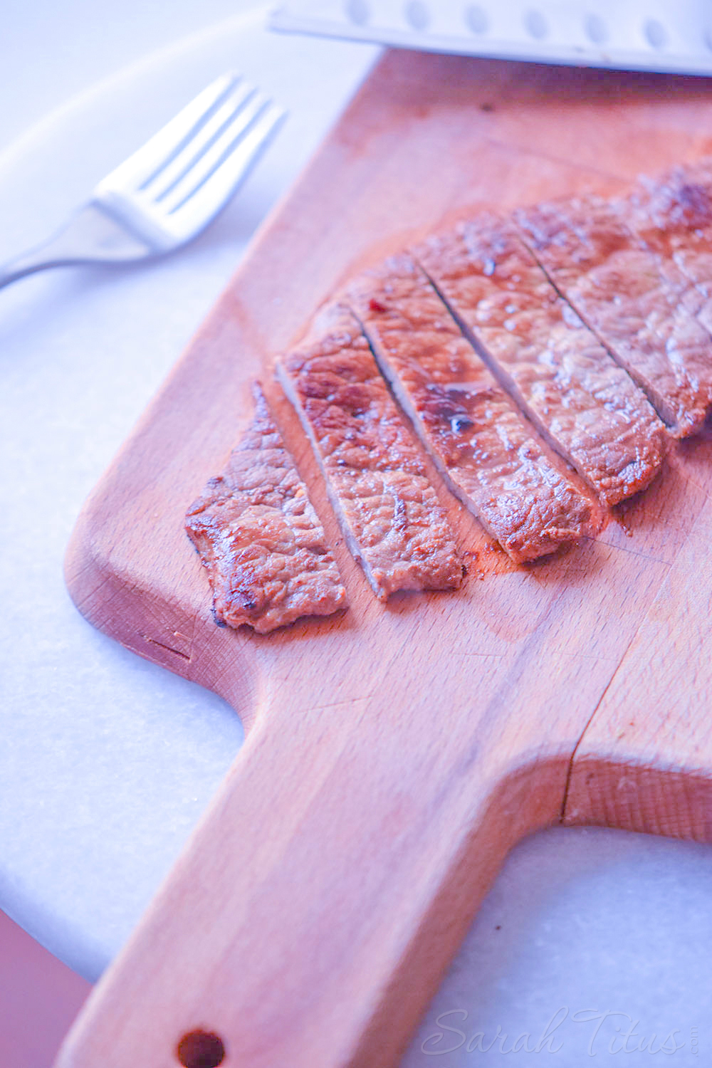 Gorgeous sliced cooked beef on a cutting board