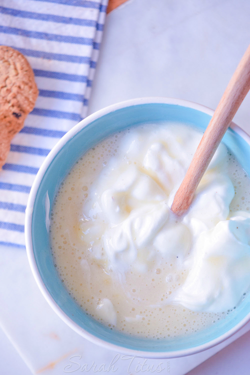 Giving the banana pudding mixture a stir with a wooden spoon