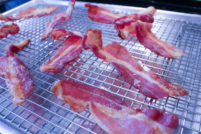 Crispy bacon on a cooling rack atop a baking sheet ready for clam chowder