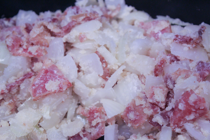 Flour stirred in to onions and baking cooking in a pan