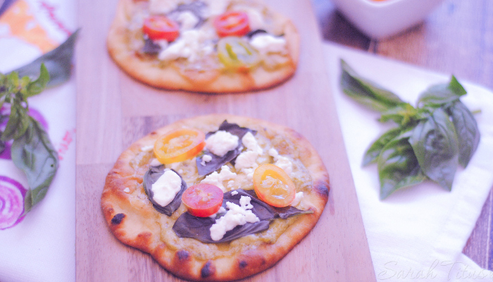 Mini Naan Pizza with tomatoes, pesto, Feta cheese, mayo and basil on Naan bread