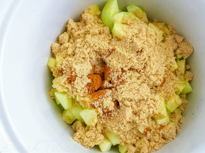Brown sugar and cinnamon poured over chopped apples in a bowl for the Crockpot Applesauce
