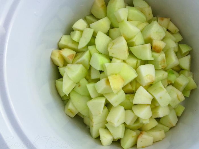 Chopped green apples in a white bowl in preparation for Crockpot Applesauce