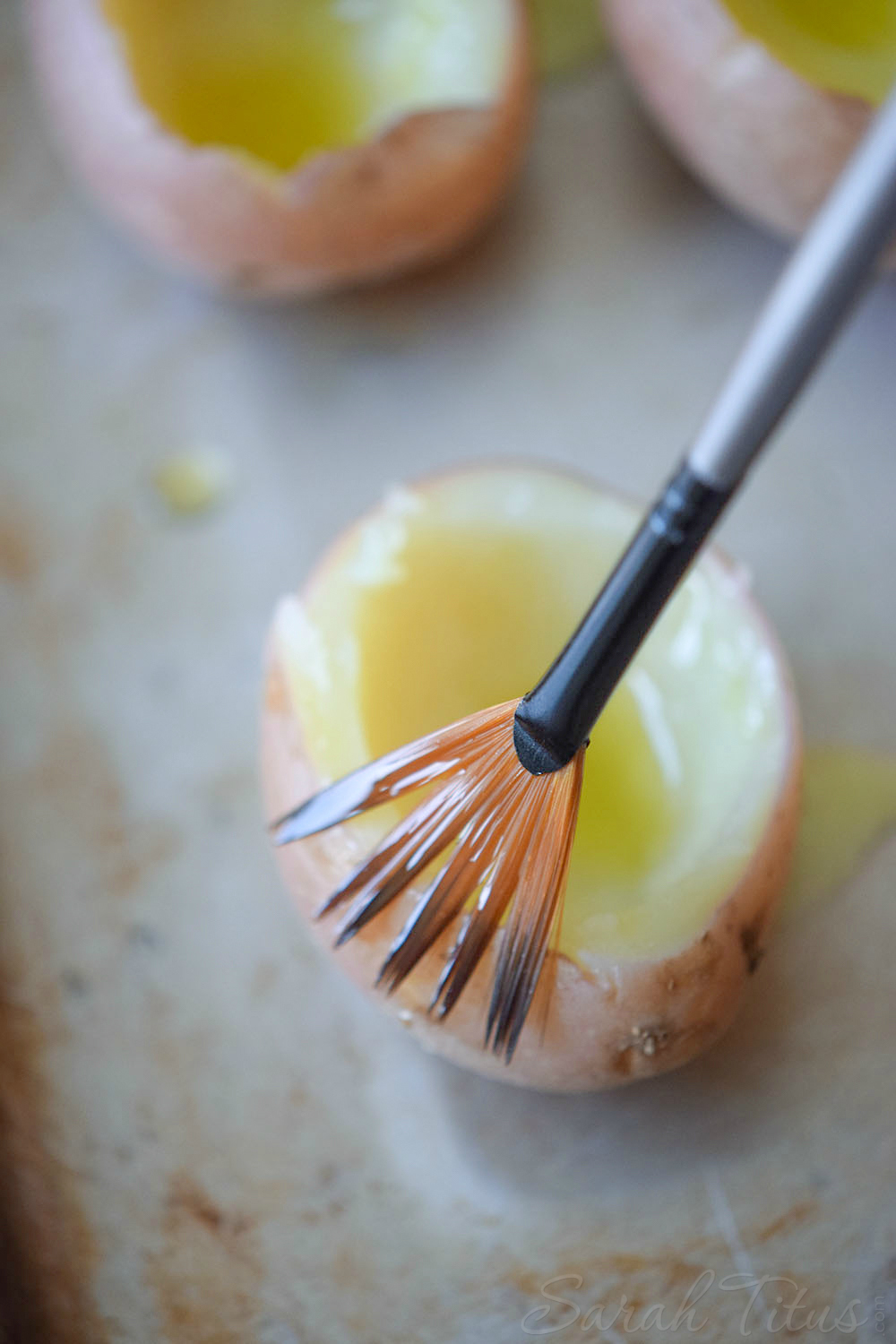 Mini Stuffed Potato Bites - Brushing the red potatoes with melted butter