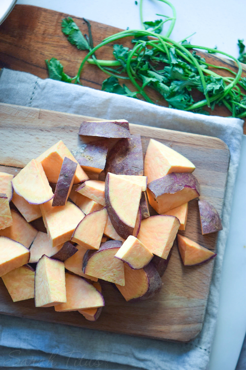 Completely chopped sweet potato on a wooden cutting board