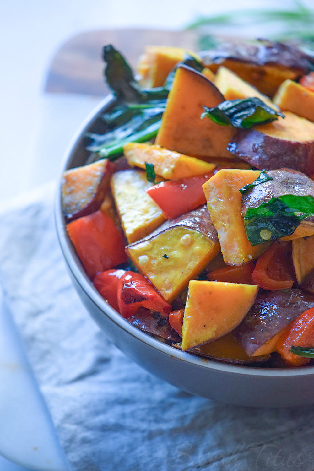 Bowl full of Colorful Sweet Potato Bake made with sweet potatoes, red peppers and spinach