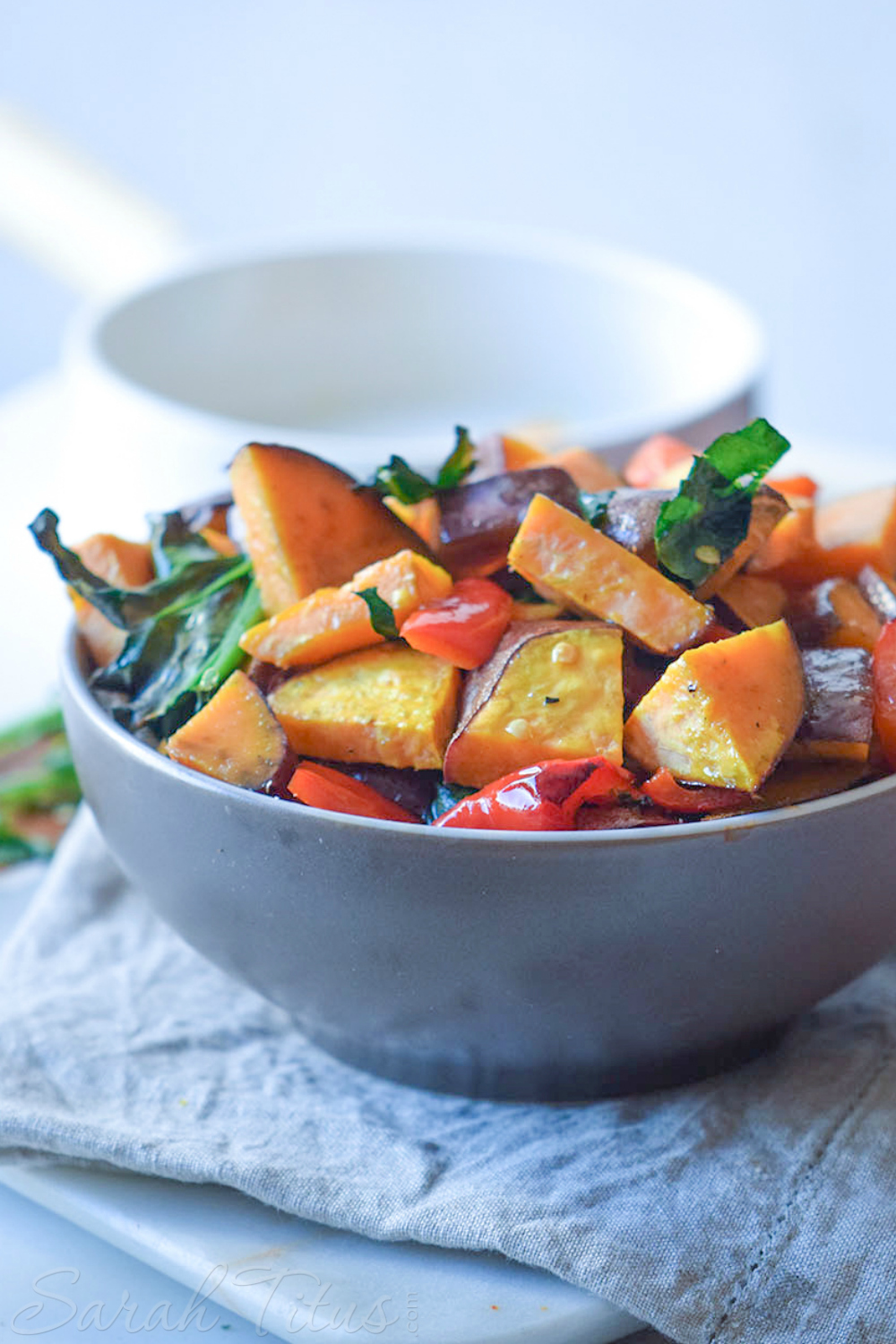 Bowl full of Colorful Sweet Potato Bake made with sweet potatoes, red peppers and spinach
