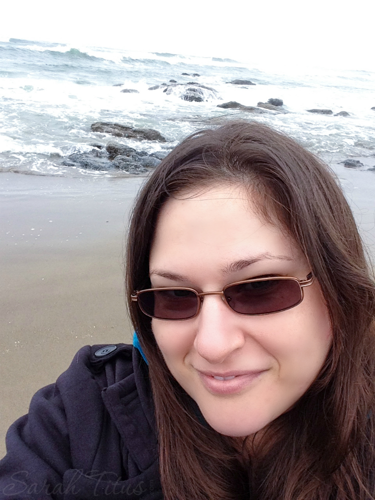 Happy lady on a cloudy beach on a road trip