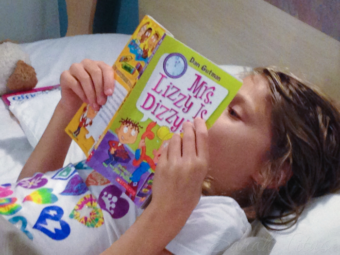 Child practicing reading at bedtime