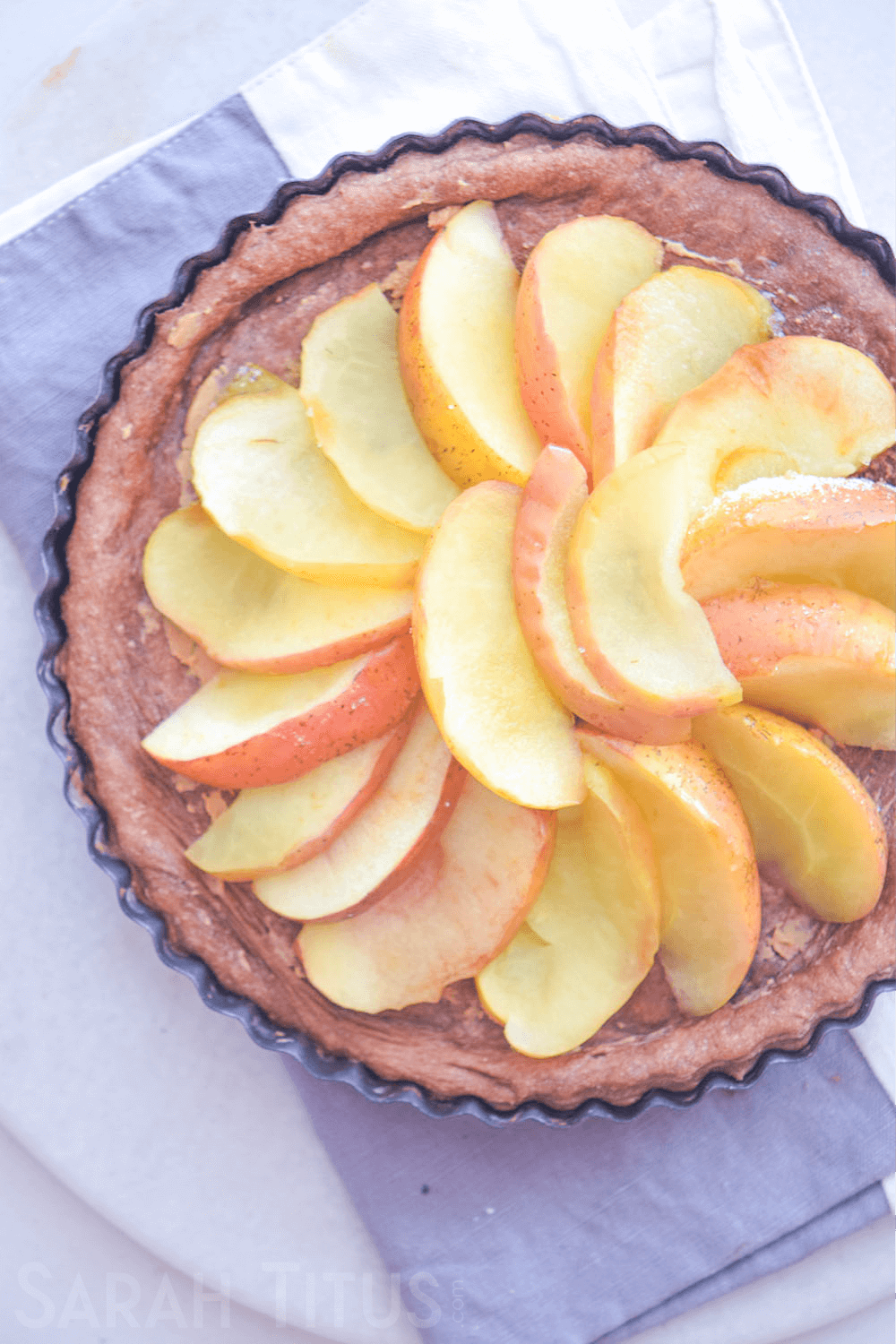 The beautifully finished circular design of apple slices on top of the pie