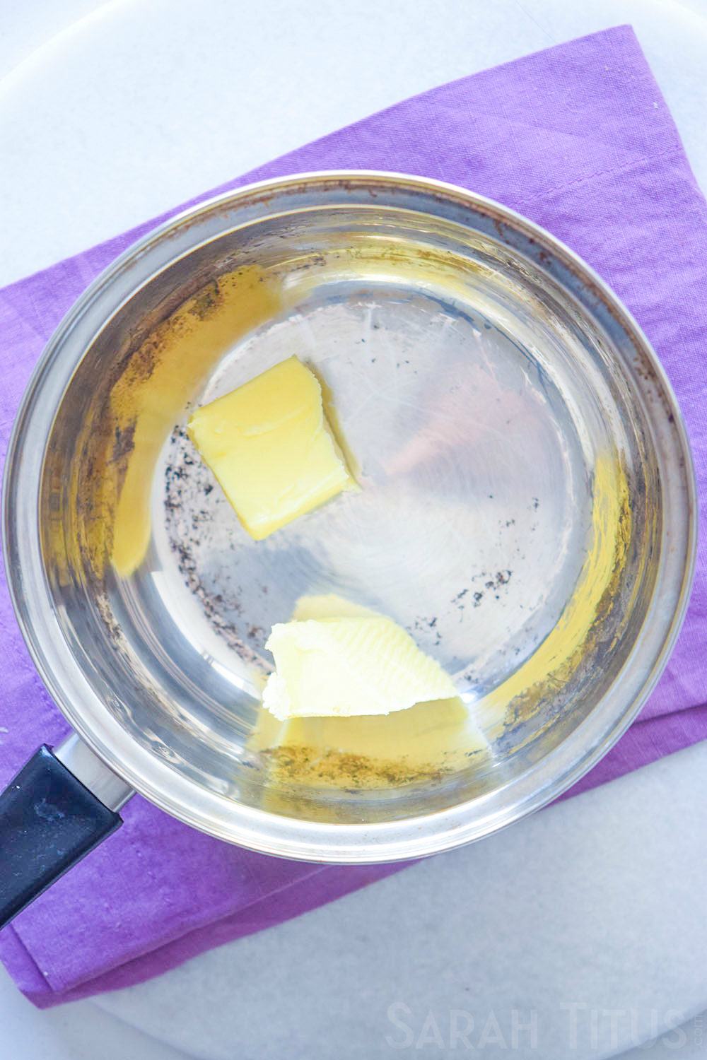 Melting butter in a pan, preparing to make potato soup