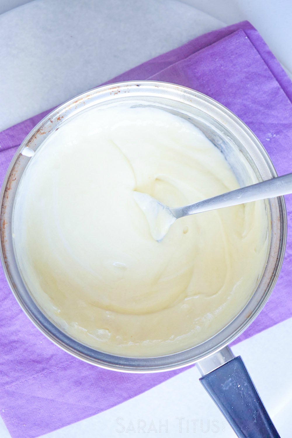 Adding in water, salt and pepper to flour, cream and butter mixture