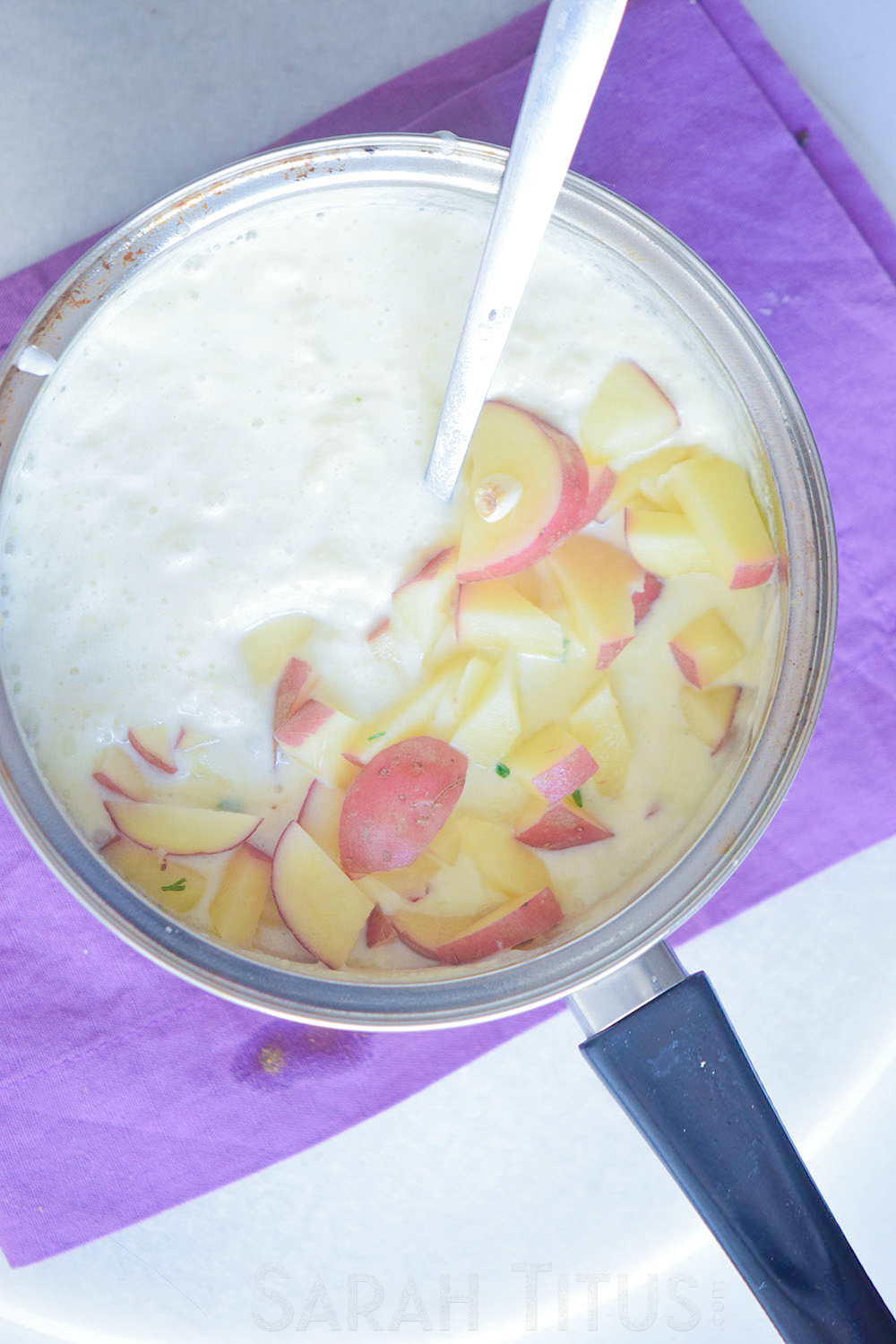 Stirring in chopped potatoes to the cream mixture