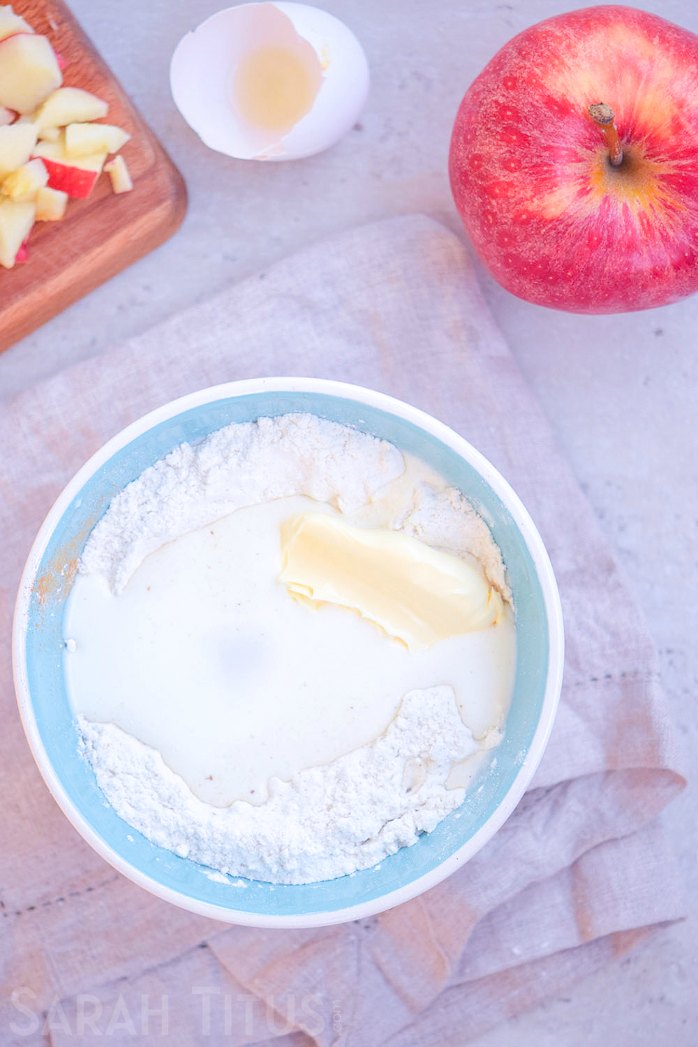 Incorporating the egg, milk, and butter to the dry ingredients in a blue bowl