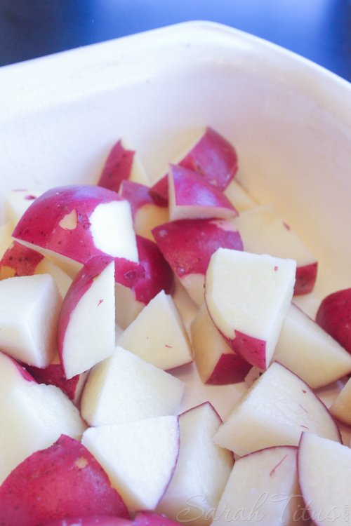 Chopped potatoes in a dish for the Potato and Polish Sausage Bake.