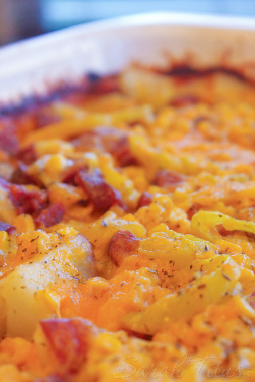 Deliciously Baked Potato and Polish Sausage Bake in a white casserole dish