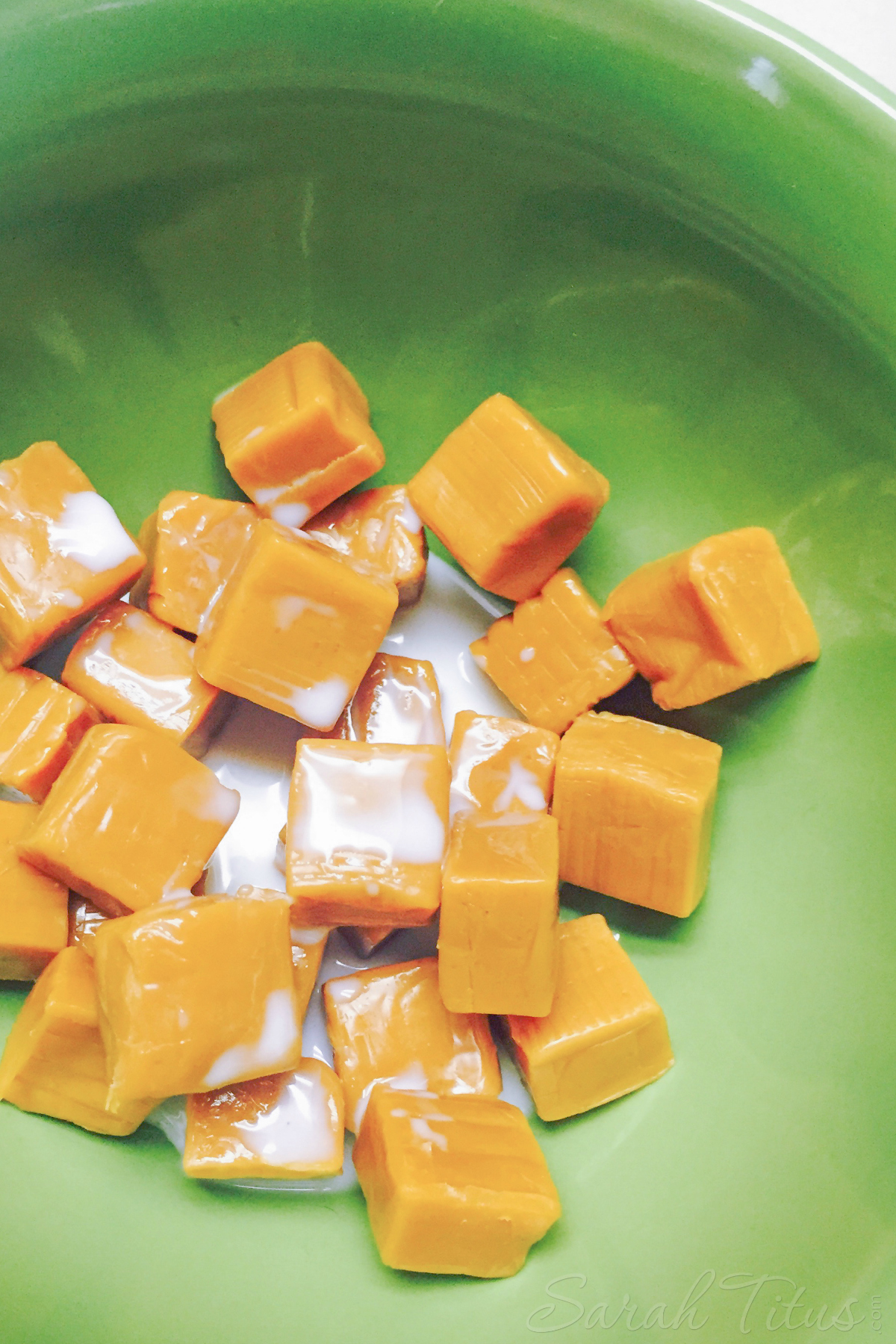 Caramels and milk in a green bowl