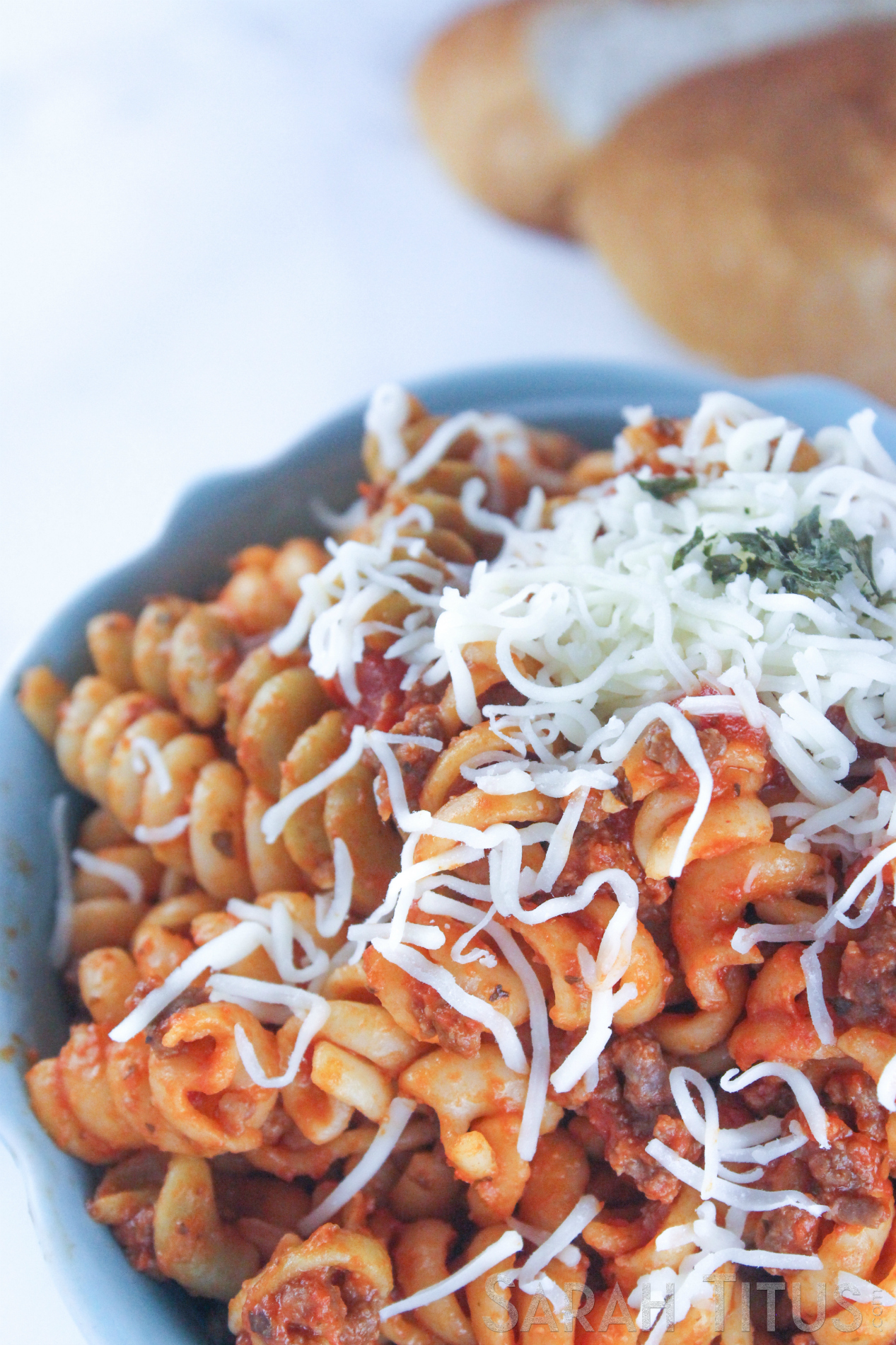 Spicy pasta with Parmesan cheese and a crusty loaf of bread