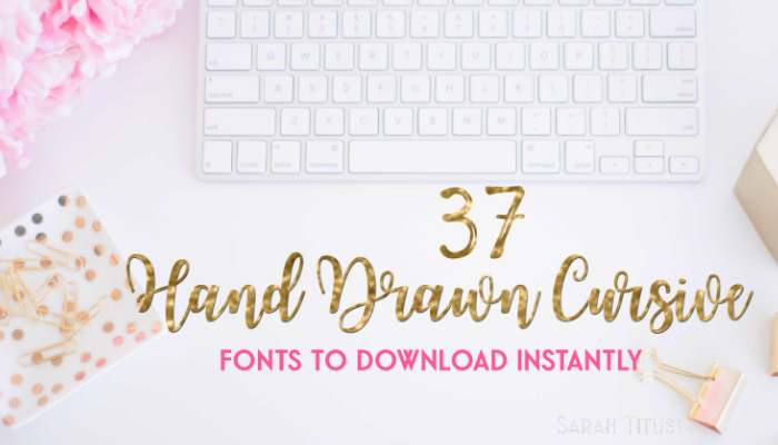 White desk and computer keyboard with pink and gold accessories for downloading fonts
