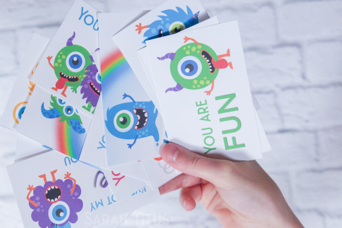 Mom holding adorable, colorful, printable monster Valentine's Day cards for kids