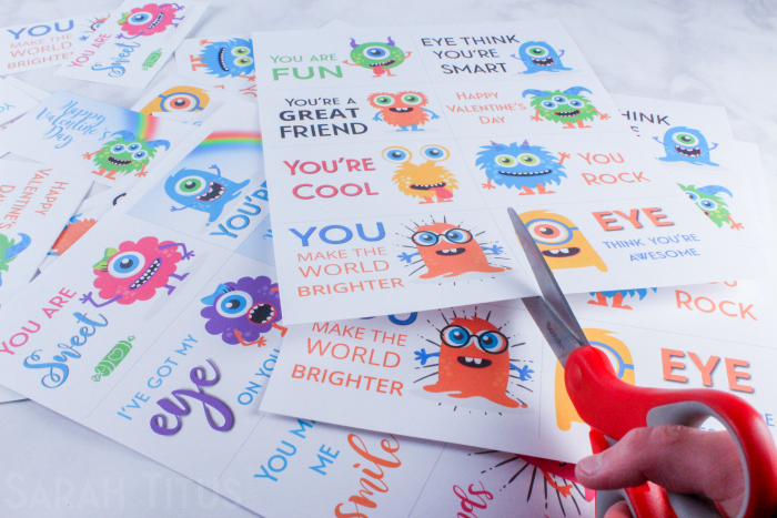 Trimming colorful printable monster Valentine's Day cards for kids