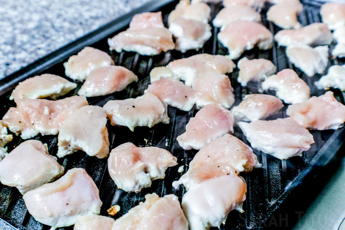 Cooking chicken pieces on an indoor grill