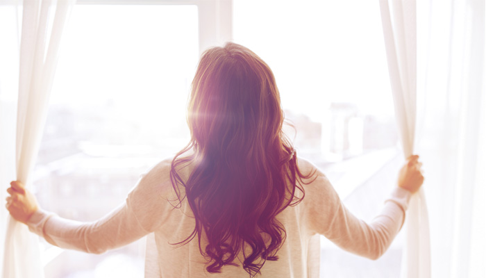  A woman is looking out the window pondering making money from home