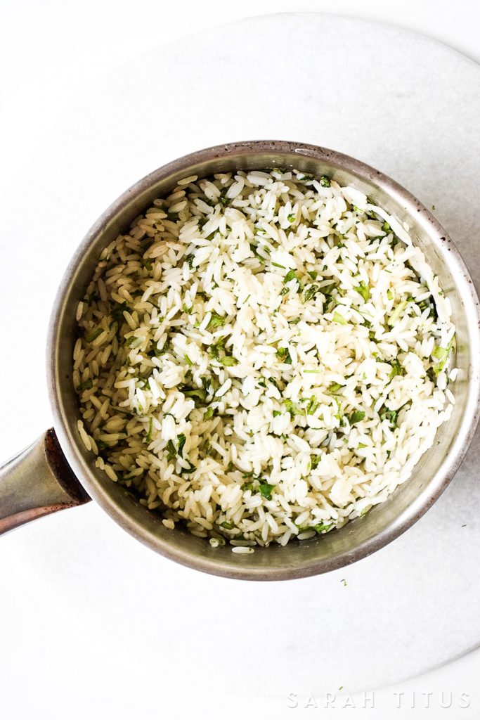 Rice is a great inexpensive side dish to add your dinner, but it is often bland and boring. This Lime Cilantro Rice is neither bland, nor boring and will have your family asking you to make more of it!