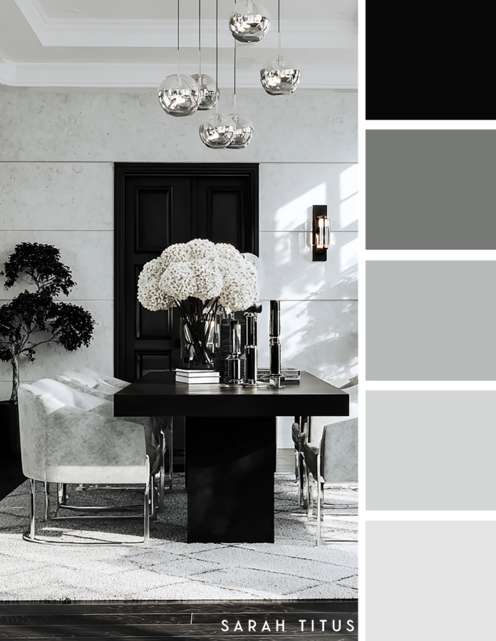 Sophisticated dining room with a black table, cream upholstered chairs, white hydrangeas, silver pendant lights, and black doors in a modern neutral color palette.